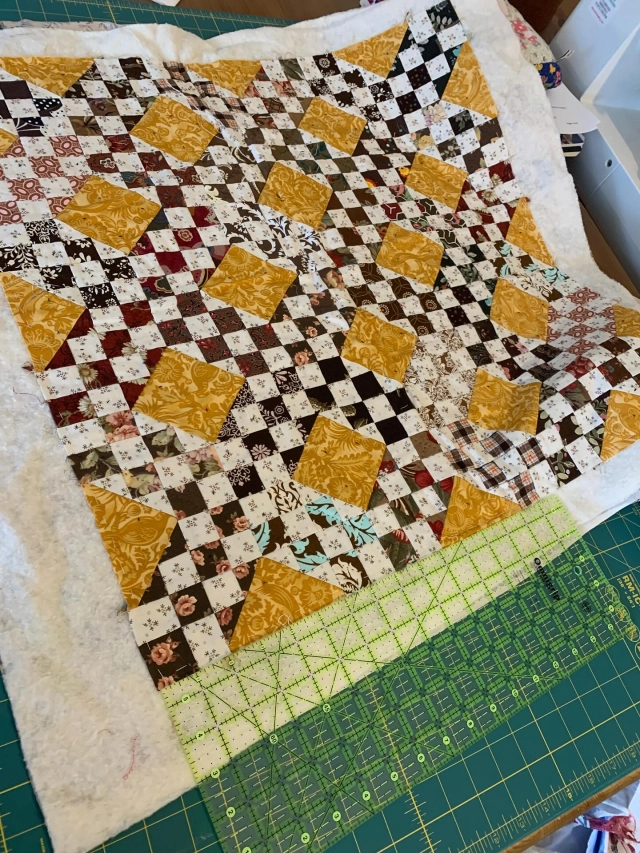So here’s a question, how long is too long to hang on to a project you know you will never finish? 
And today the time for this one is up. I think I’ve struggled with this as it’s only small (24in square approximately) and I had started to hand quilt it. 
But I’ve got to the stage of being honest and after about 20yrs it’s not going to happen. 
So before it’s consigned to the textile recycling, do you want to finish it? I know it could be a great base for some great textile experiments, over dye, applique, cut up and re stitch, you know, channel your @afullenglish or @russelljamesbarratt 🤓🧵🪡. It could be a cat quilt, a dolly quilt, a table mat, a bag, it can have a future!

Edited: taken! On its way to its best life! ☺️

I’ll send it anywhere in the UK, just comment below! #reusereducerecycle♻️🌎🍃💚 #miniquilt #unfinished #patchwork #patchworkquilt #carolynforster #carolynforsterquilts