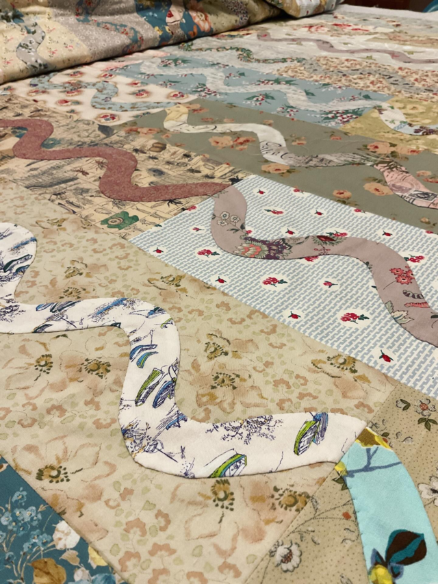 And in the spirit of getting things done, I started hand basting the layers of my latest quilt. Some tops get put together and then left to mature, but others need to e quilted and when I have the idea I keep going. I had baste for preference and indulgence 😆🪡🧵. 
One reason is that it really gives you time to absorb the quilt as you think about the quilting. 
This is a prime example, as I was pretty sure how this would be quilted. 
But in the end I was wrong. It’s going a different way now, and I’m so happy with the second idea. 
Onwards…. #quiltbasting #quilttop #handapplique #carolynforster #quiltingonthego
