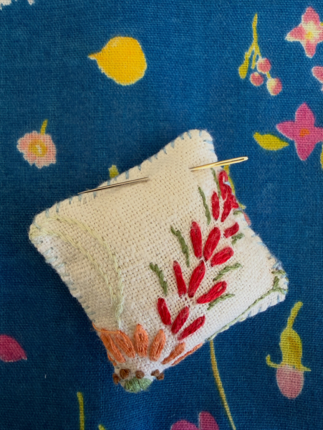 Day 10 @seam_collective and the prompt is Low Impact.

The making of patchwork quilts has often been associated with the using up of fabric scraps and worn clothing, and I try to keep this in focus with a lot of my quilts. I do buy new fabrics and I try to look out for any environmental tags to do with dyes, dying and ethical production. 
I also try to use every last piece, and these fabric beads, charms or mini pin cushions are pretty true to that.
I re use old embroidered table linens in some of my quilts and these tiny pieces that come from the cutting out are always kept. Then when the mood or the idea strikes, they come into their own.
#reusereducerecycle #fabricscraps #pincushion #septtextilelove #carolynforster