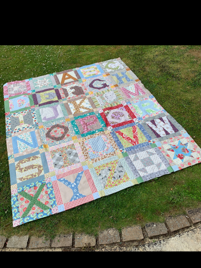 @seam_collective , day 11, language.
 
No matter what language you speak we all understand the meaning behind making and sometimes giving a quilt. We all understand what draws each of us to stitch and share our joy of stitching.
#alphabetquilt #patchwork #scrapquilt #carolynforster #septtextilelove26
