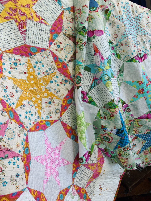 @seam_collective and the prompt today is Celebration.

I do think every quilt made is cause for a celebration 🎉. All the time, effort, thought and love that goes into a quilt should never be taken for granted. Many of the quilts we see in museums are only there because they were saved for best. But really quilts are made to be used, and it’s those tatty ones that might not get their museum place which I think are the most celebrated. Having fulfilled their destiny daily on beds in homes. 
The quilt in the picture in two colour ways is my latest celebration share with folks in class’s and with the pattern and templates that you can use to stitch and celebrate your own! 
Twirling Stars is available from me , £25 UK postage included. Just email via my website , and sign up to my newsletter to see what’s happening this autumn! 
#twirlingstars #twirlingstarsquilt #handpeicedpatchwork #handpiecedquilt #carolynforster